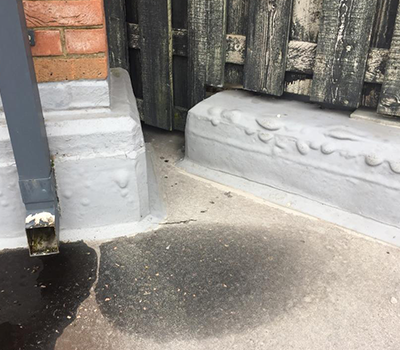 Image of asphalt failing at the details and interfaces